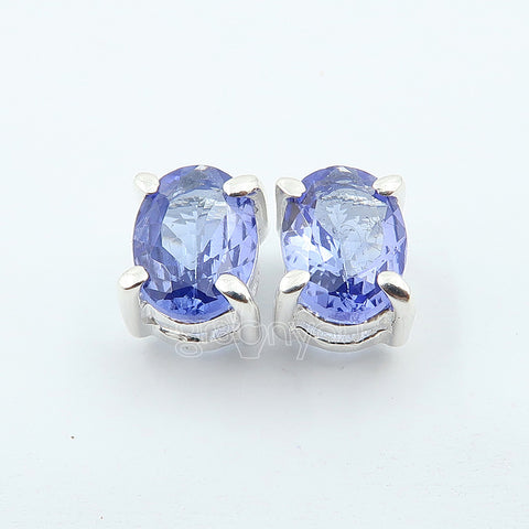 Pair of blue gemstone earrings on a white background